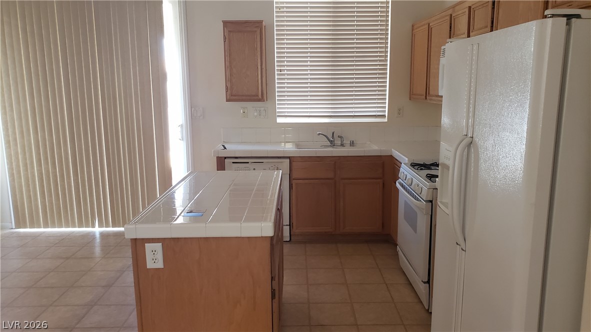 9112 Manalang Road Las Vegas, NV 89123 - Photo 37 of 50 A functional kitchen boasts ample counter space and convenient island for meal preparation.