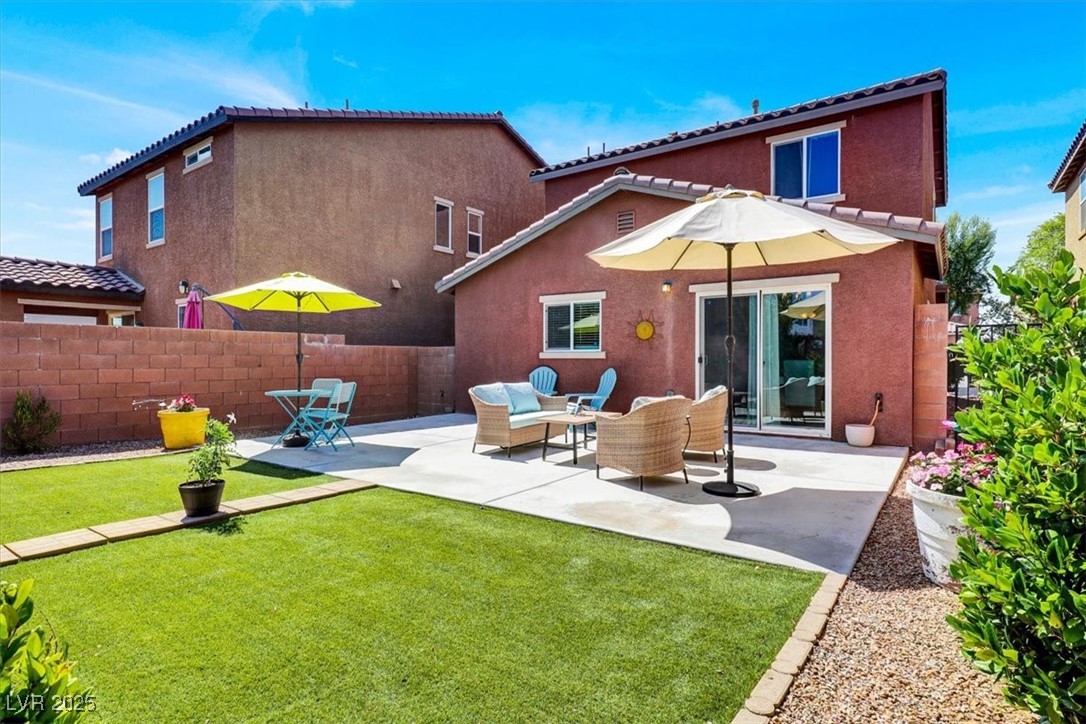 9236 Keystone Ridge Avenue Las Vegas, NV 89148 - Photo 9 of 38 Rear view of house with a patio, and an outdoor living space, artificial grass