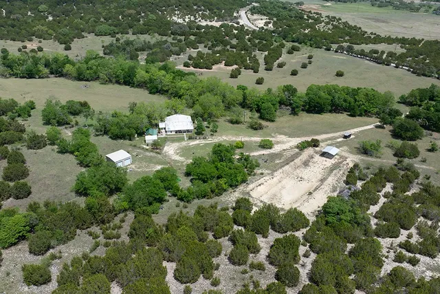 an aerial view of residential houses with outdoor space