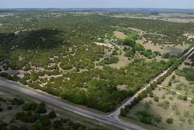 a view of a green field with lots of trees