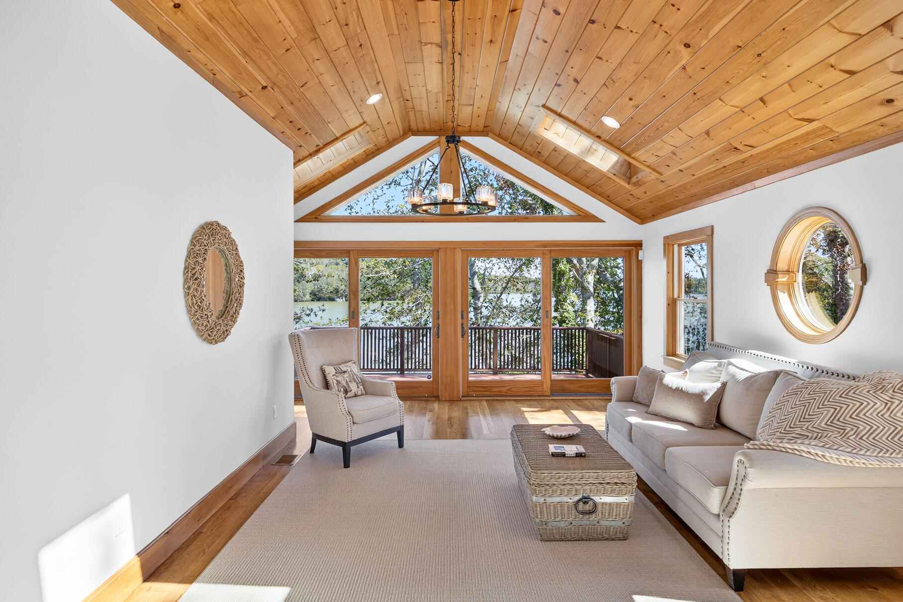 131 Timberlane Drive Mashpee, MA 02649 - Photo 28 of 57 a living room with furniture a large window and a chandelier