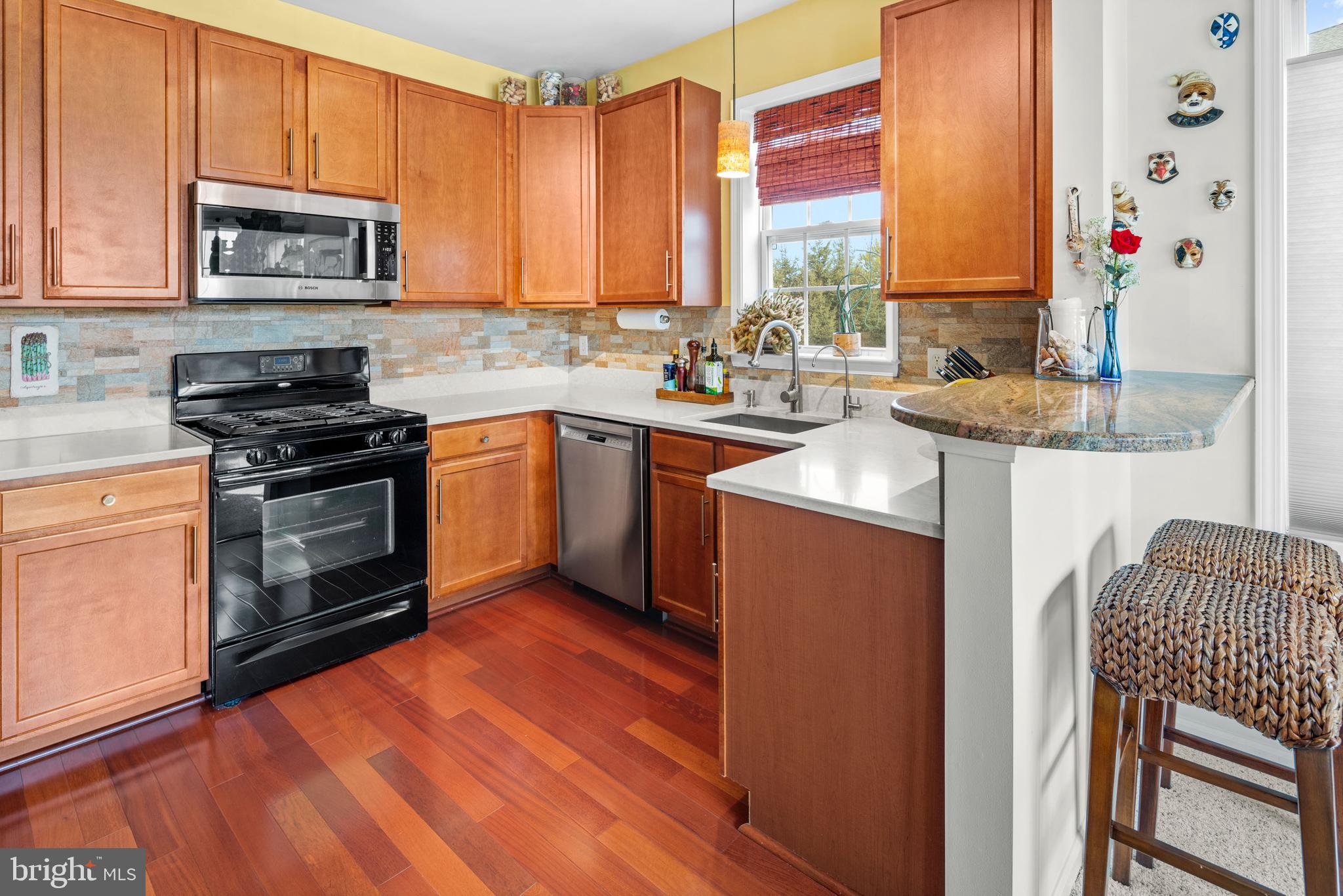 227 Timberlake Drive Ewing, NJ 08618 - Photo 8 of 21 a kitchen with stainless steel appliances granite countertop a stove a sink and a microwave