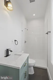 a bathroom with a toilet and shower