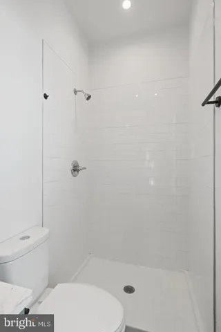 a bathroom with a toilet and shower