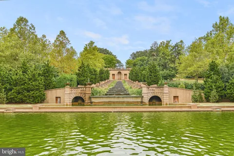 a view of a large body of water with a house in the background