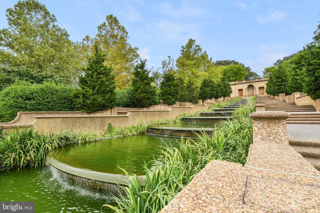 a view of a large body of water with a house in the background