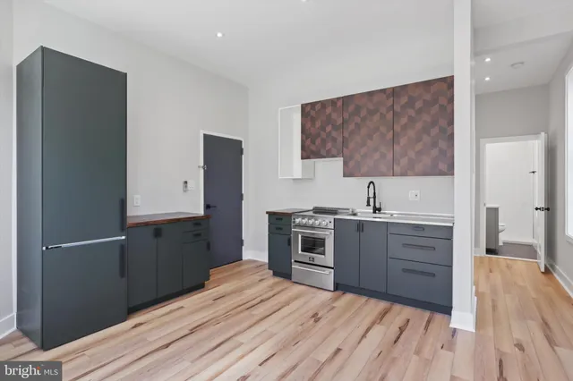 a room with a bed and a dresser