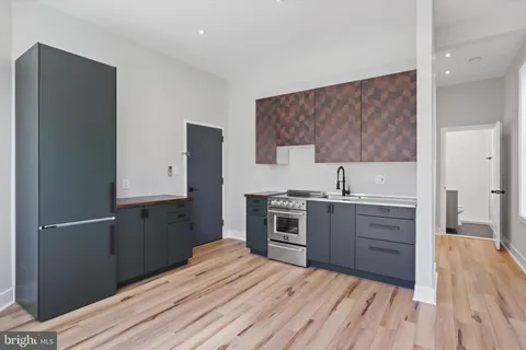 a kitchen with a refrigerator and a sink