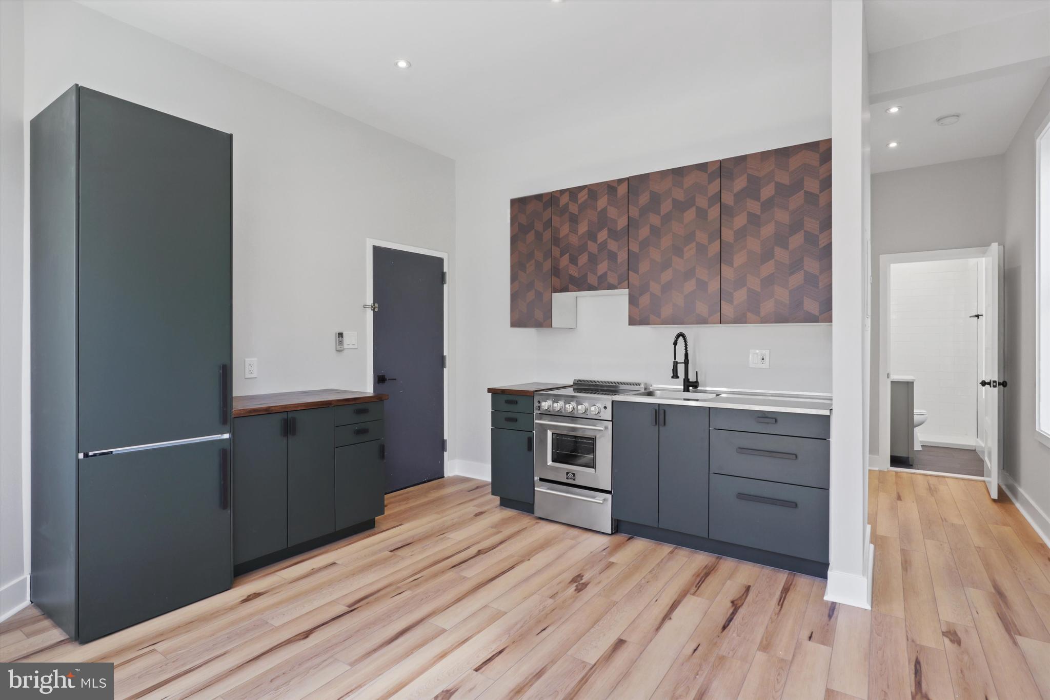3504 13th Street Northwest, Unit 12 Washington, DC 20010 - Photo 5 of 24 a kitchen with a refrigerator and a sink