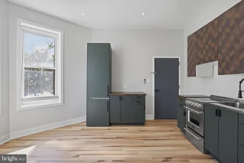 a kitchen with stainless steel appliances granite countertop a refrigerator stove and sink
