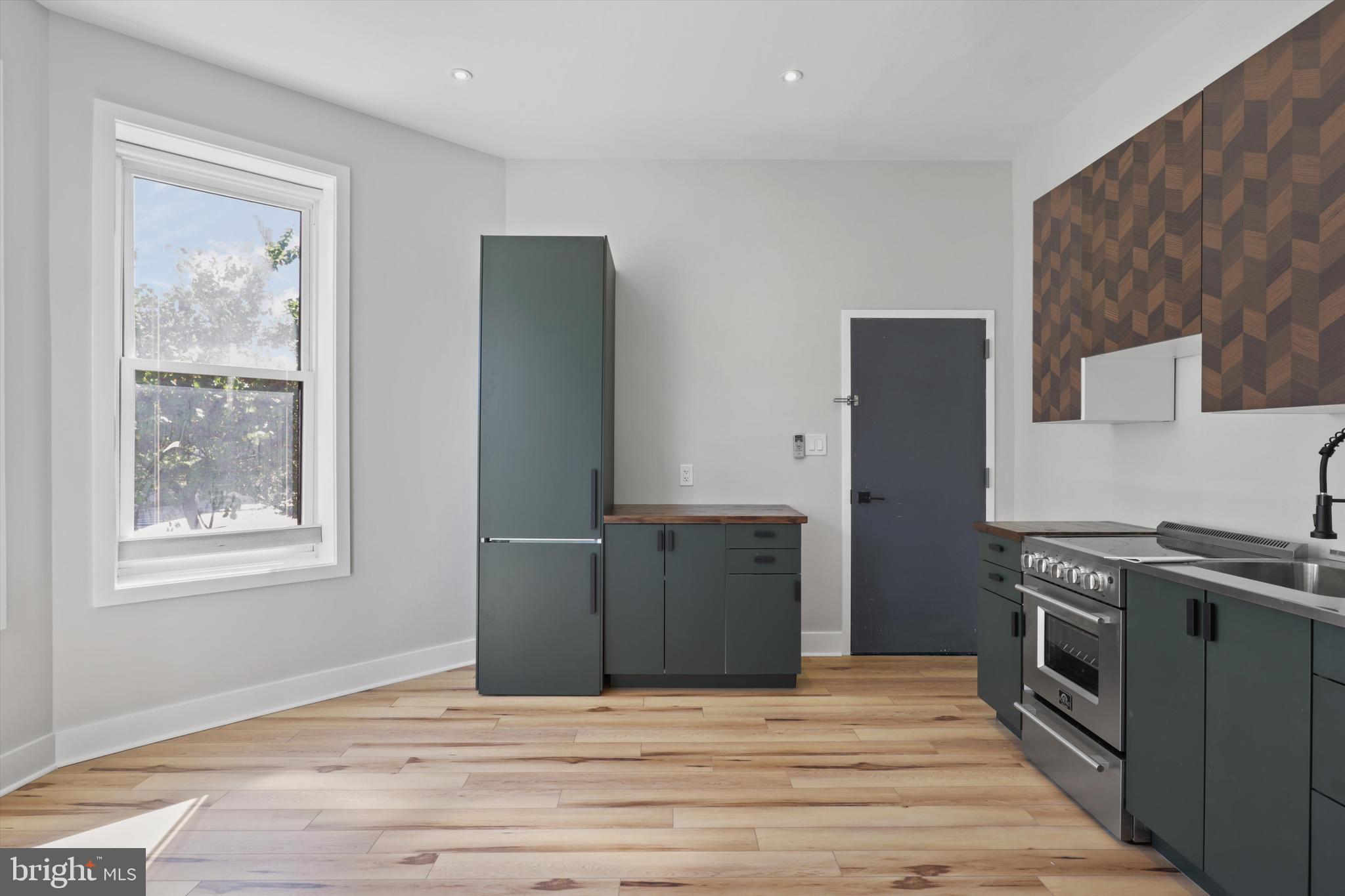 3504 13th Street Northwest, Unit 12 Washington, DC 20010 - Photo 6 of 24 a kitchen with stainless steel appliances granite countertop a refrigerator stove and sink