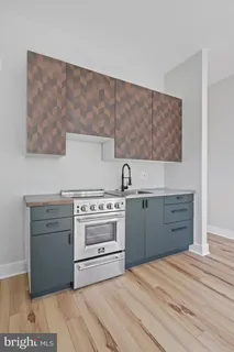a kitchen with granite countertop a stove and a sink