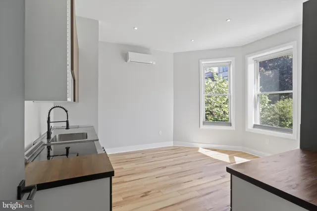 a kitchen with granite countertop a stove and a sink