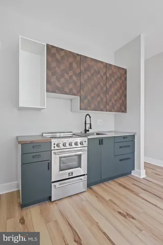 a kitchen with cabinets stove and oven