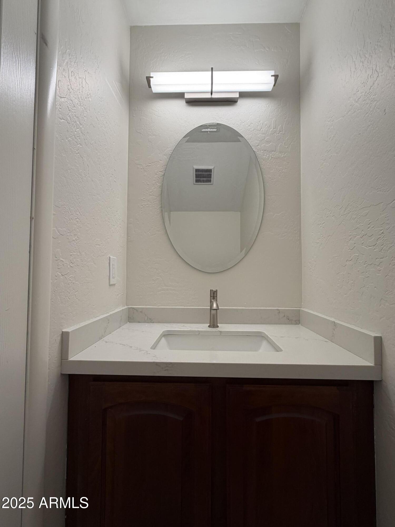 4434 East Annette Drive Phoenix, AZ 85032 - Photo 12 of 27 a bathroom with a sink and a mirror
