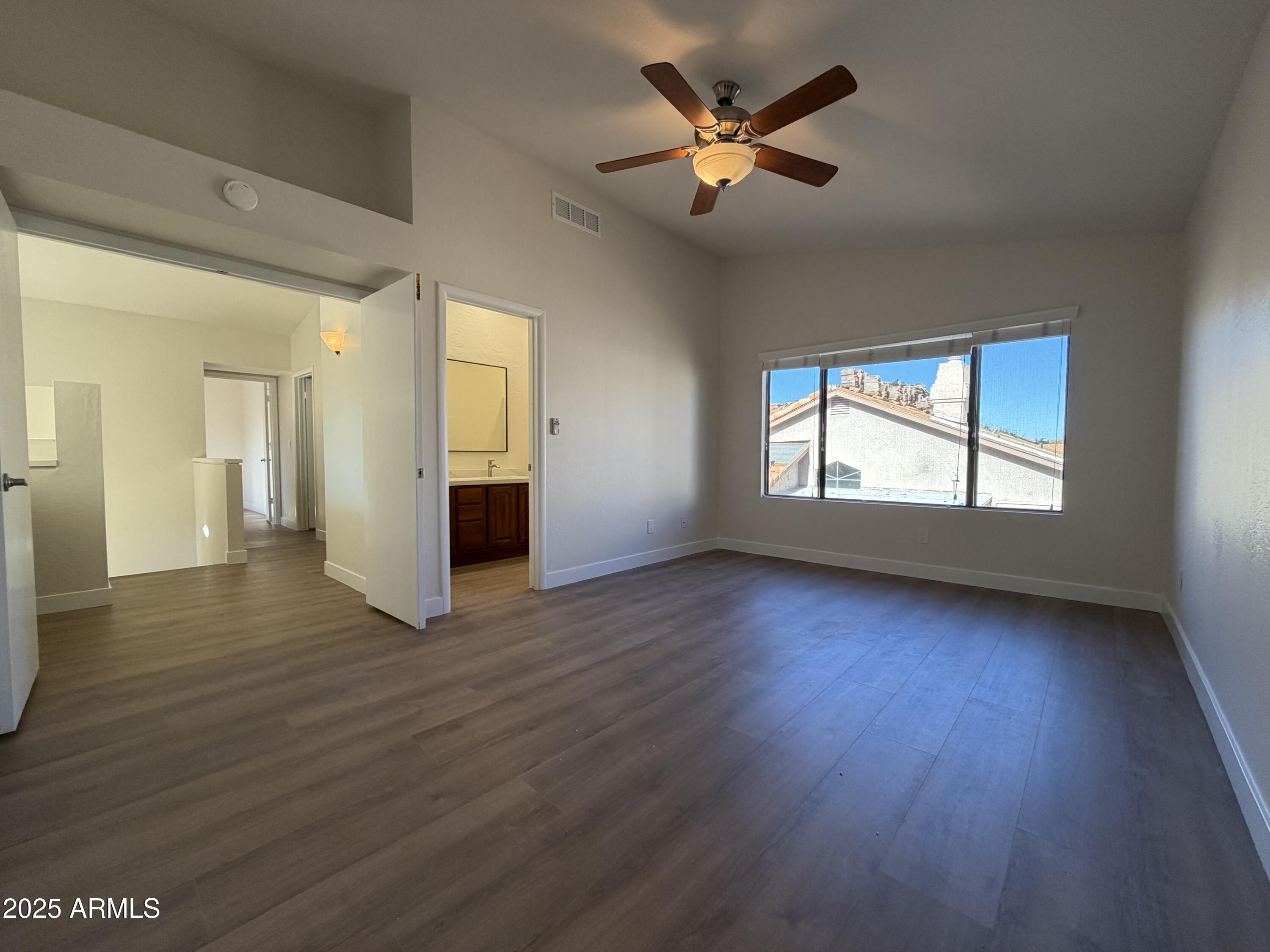 4434 East Annette Drive Phoenix, AZ 85032 - Photo 15 of 27 an empty room with wooden floor and windows