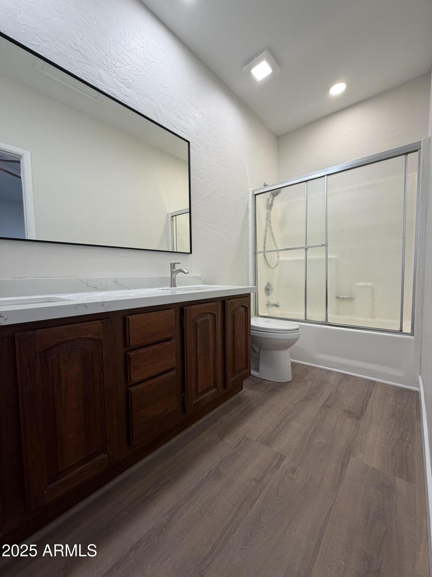 4434 East Annette Drive Phoenix, AZ 85032 - Photo 19 of 27 a bathroom with a double vanity sink a toilet and a mirror