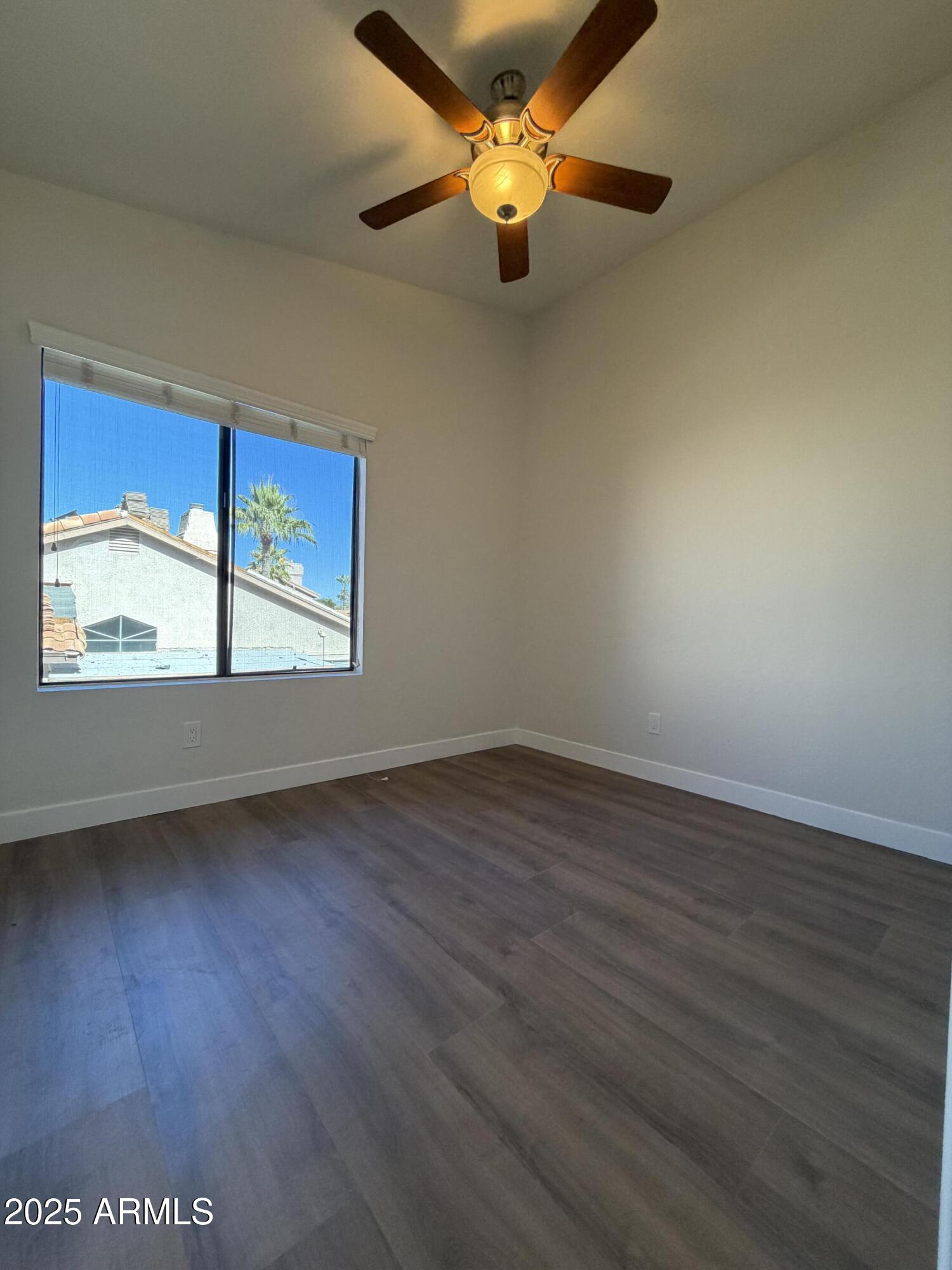 4434 East Annette Drive Phoenix, AZ 85032 - Photo 20 of 27 wooden floor in an empty room with a window