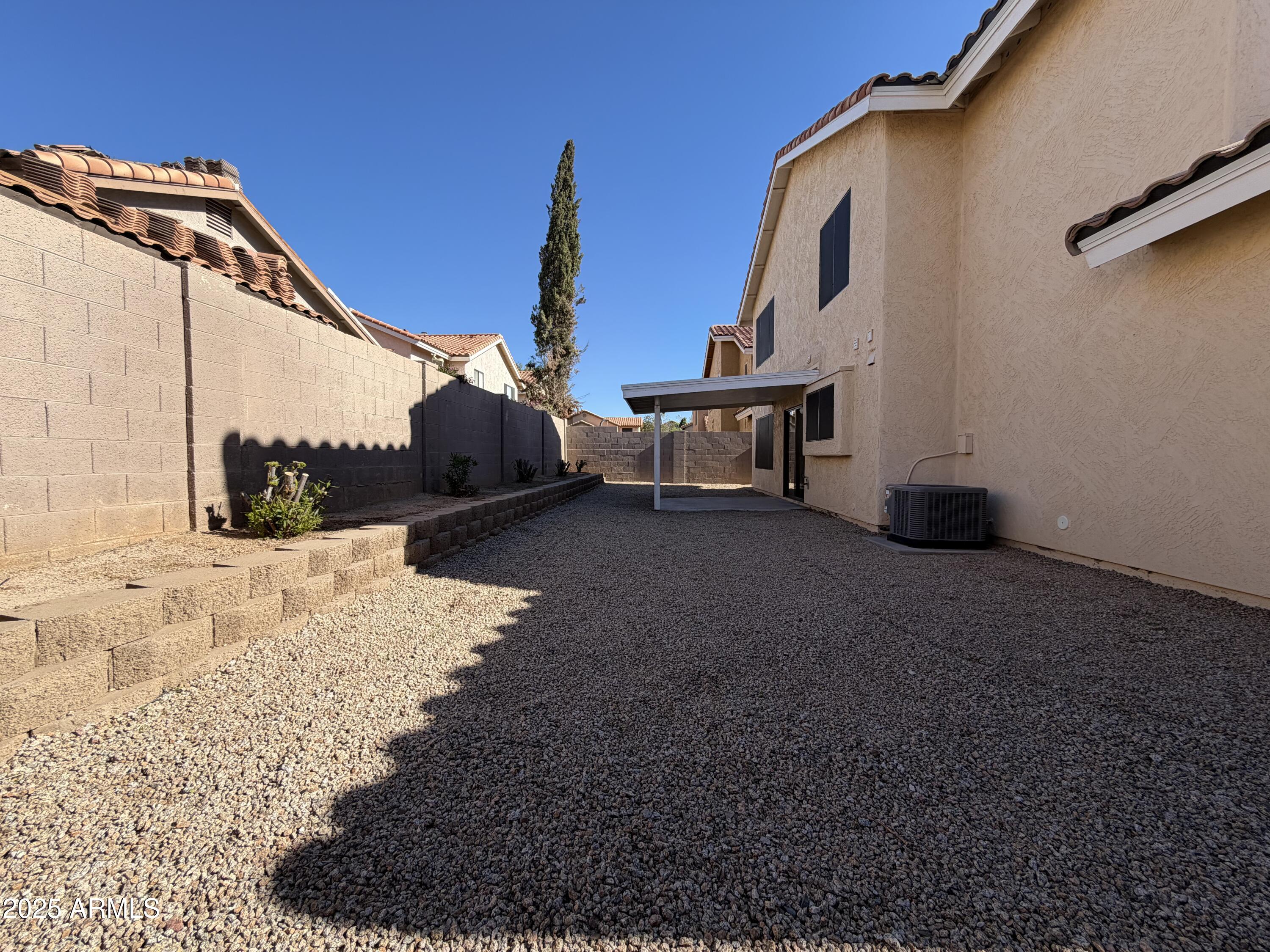 4434 East Annette Drive Phoenix, AZ 85032 - Photo 25 of 27 a backyard of a house with a table and chairs