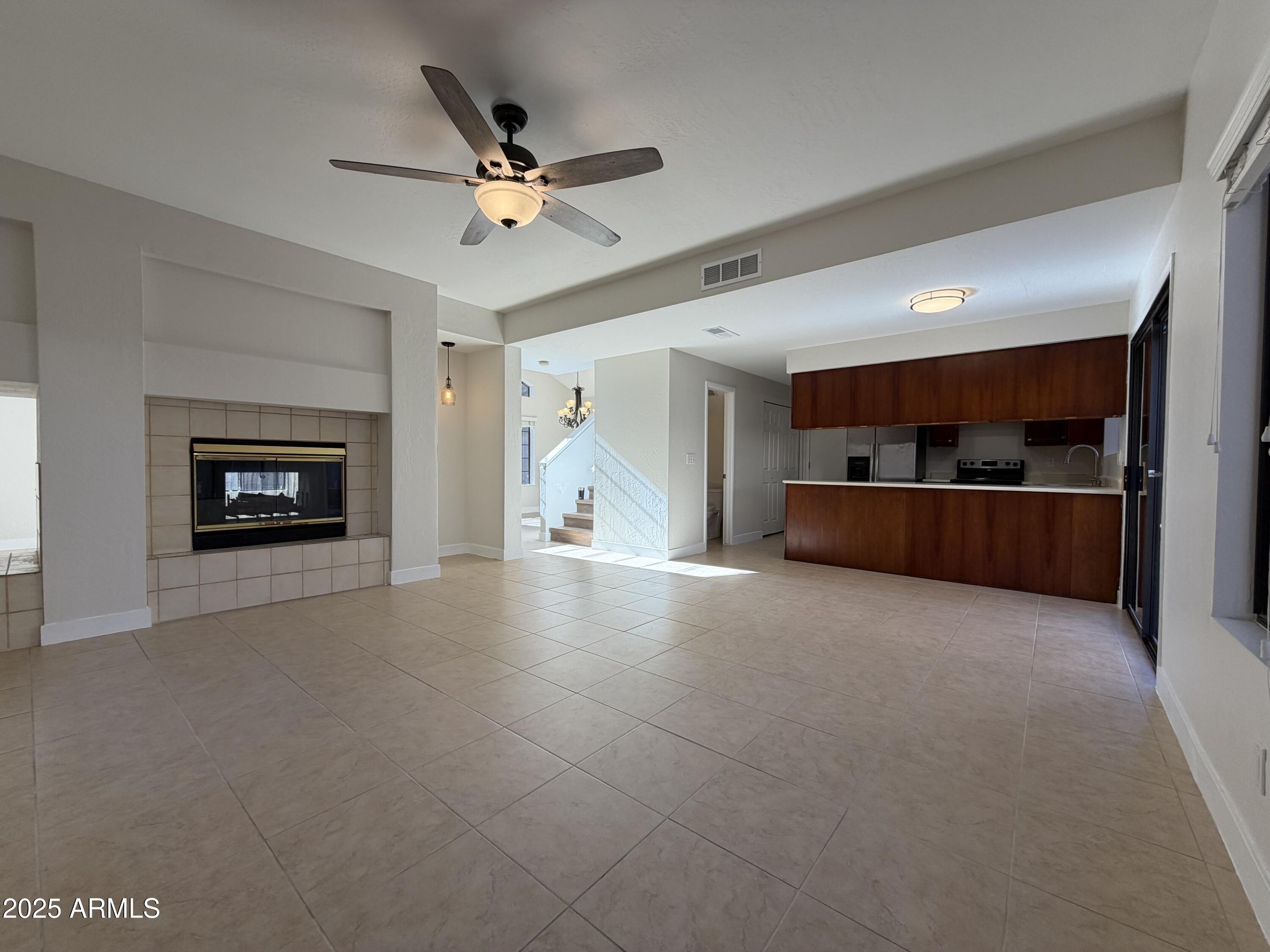 4434 East Annette Drive Phoenix, AZ 85032 - Photo 6 of 27 a view of a livingroom with fireplace and a ceiling fan