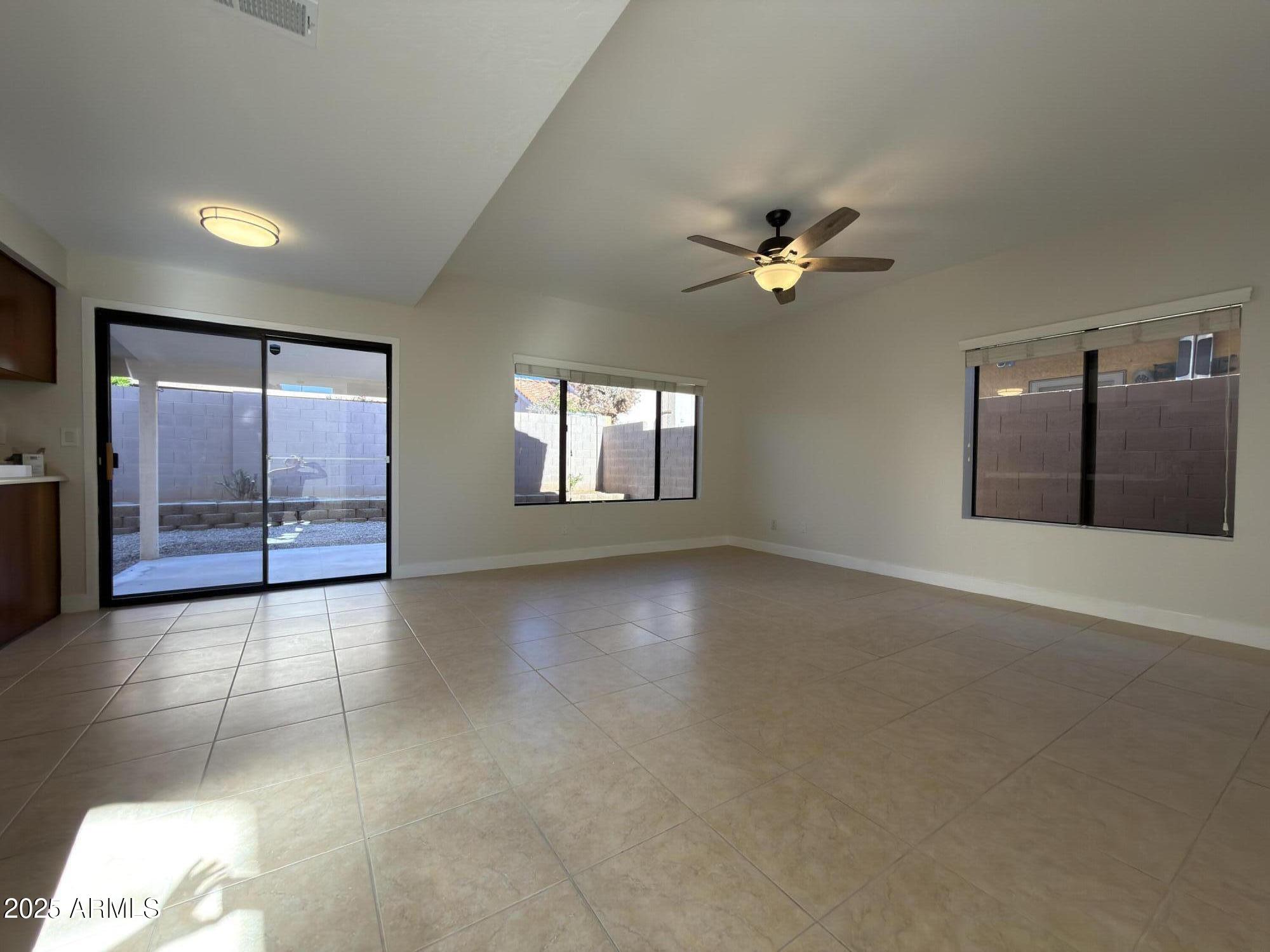 4434 East Annette Drive Phoenix, AZ 85032 - Photo 7 of 27 a view of a livingroom with a ceiling fan and window