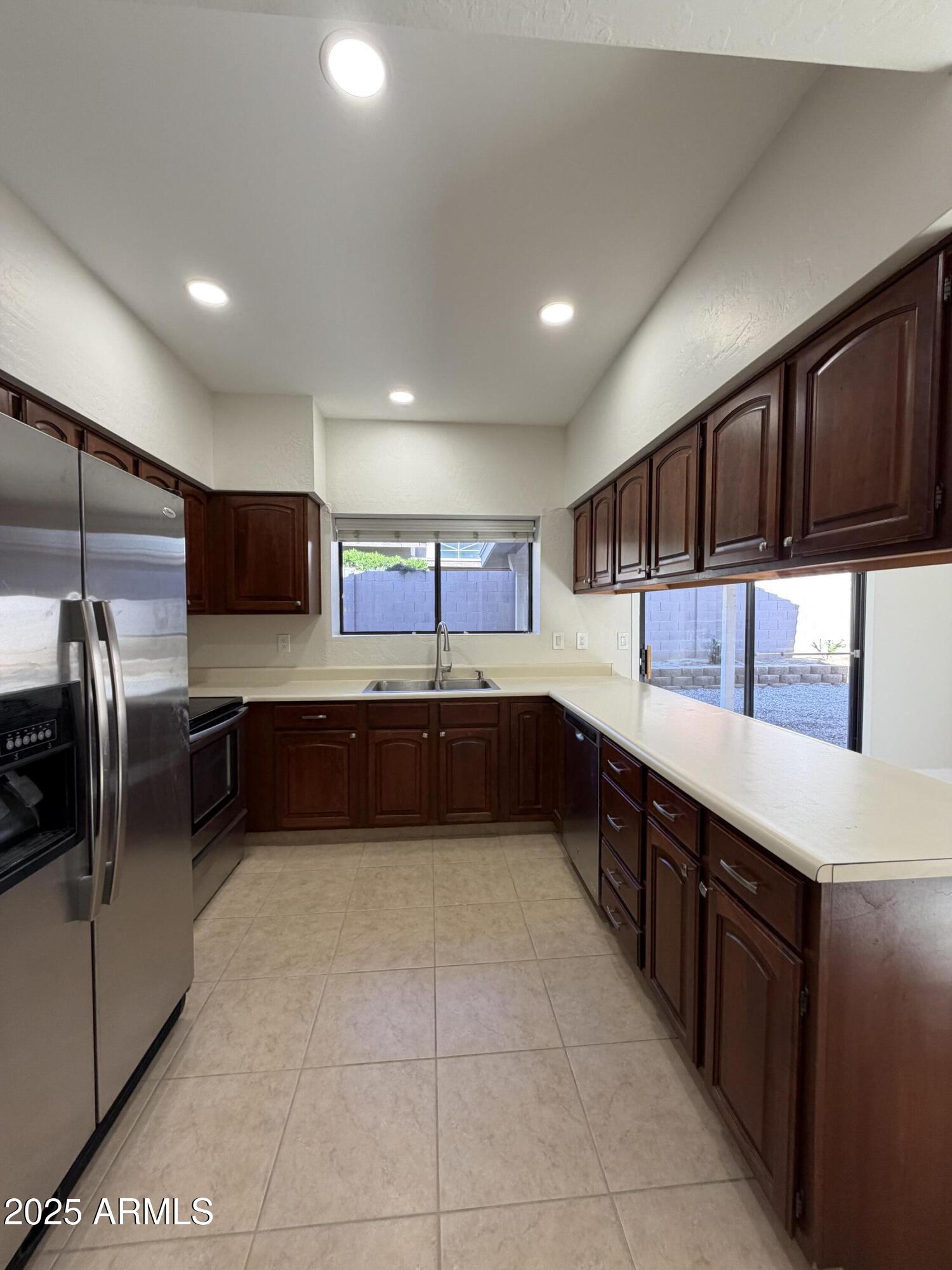 4434 East Annette Drive Phoenix, AZ 85032 - Photo 10 of 27 a large kitchen with a large counter top stainless steel appliances and cabinets