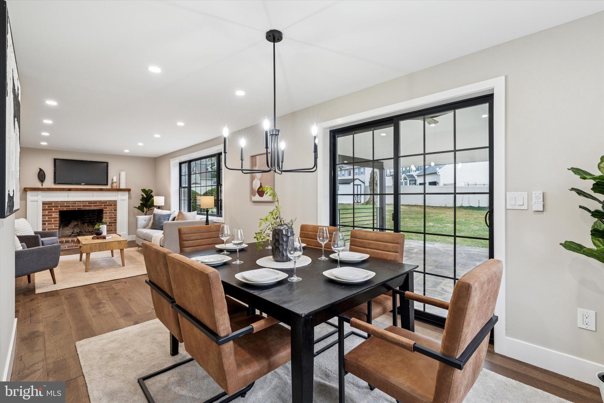 306 Greenhill Road West Chester, PA 19380 - Photo 14 of 42 a dining room with furniture a chandelier and wooden floor
