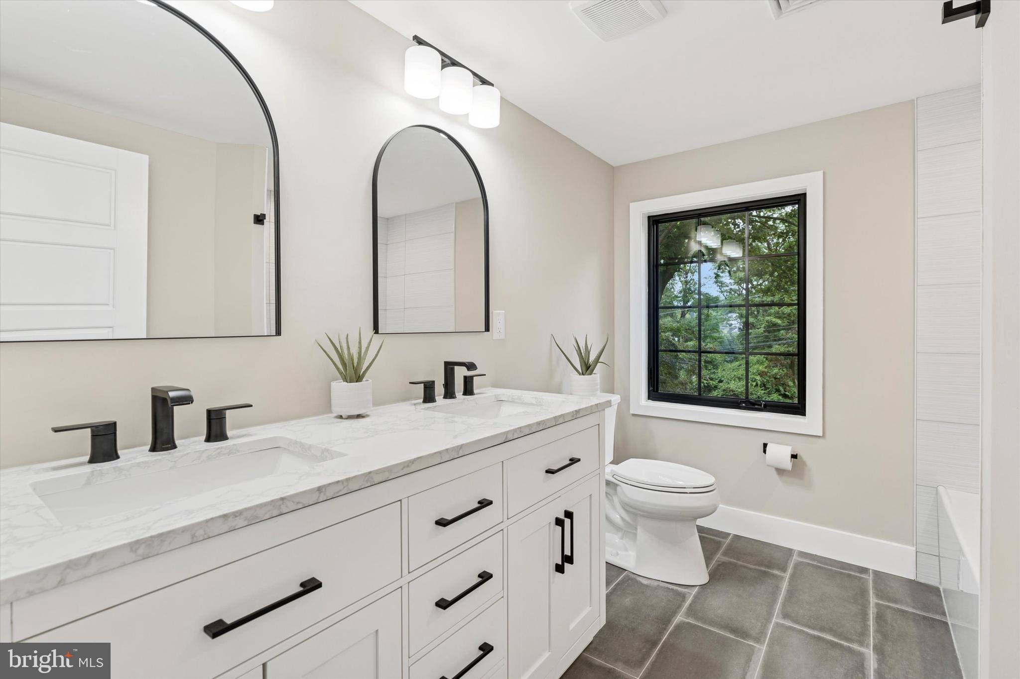 306 Greenhill Road West Chester, PA 19380 - Photo 24 of 42 a bathroom with a double vanity sink toilet and a mirror