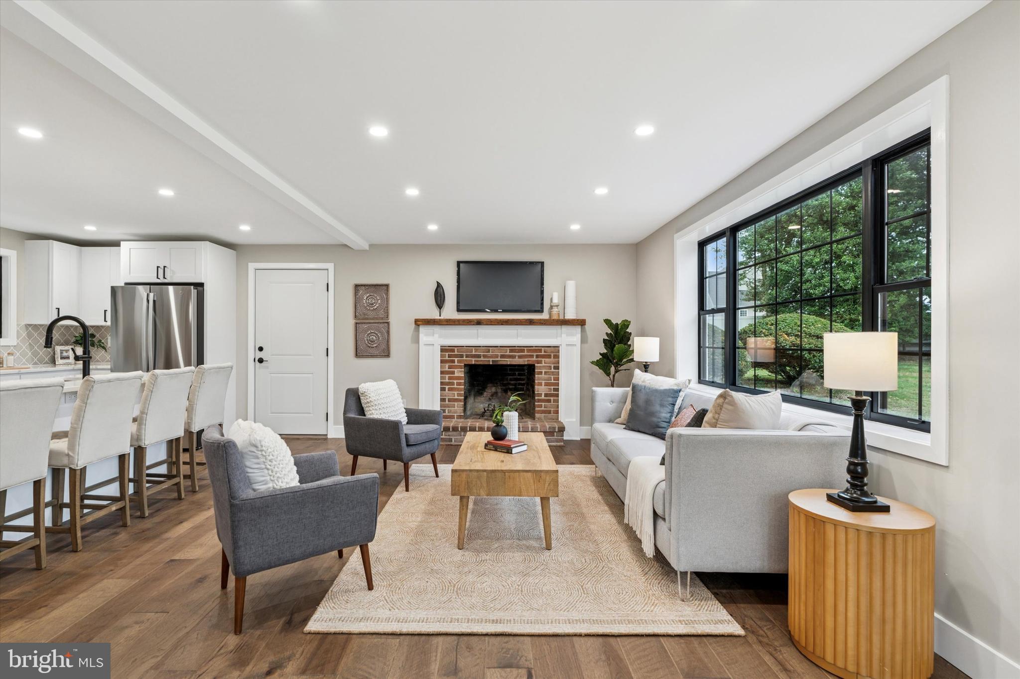 306 Greenhill Road West Chester, PA 19380 - Photo 4 of 42 a living room with furniture a large window and a fireplace