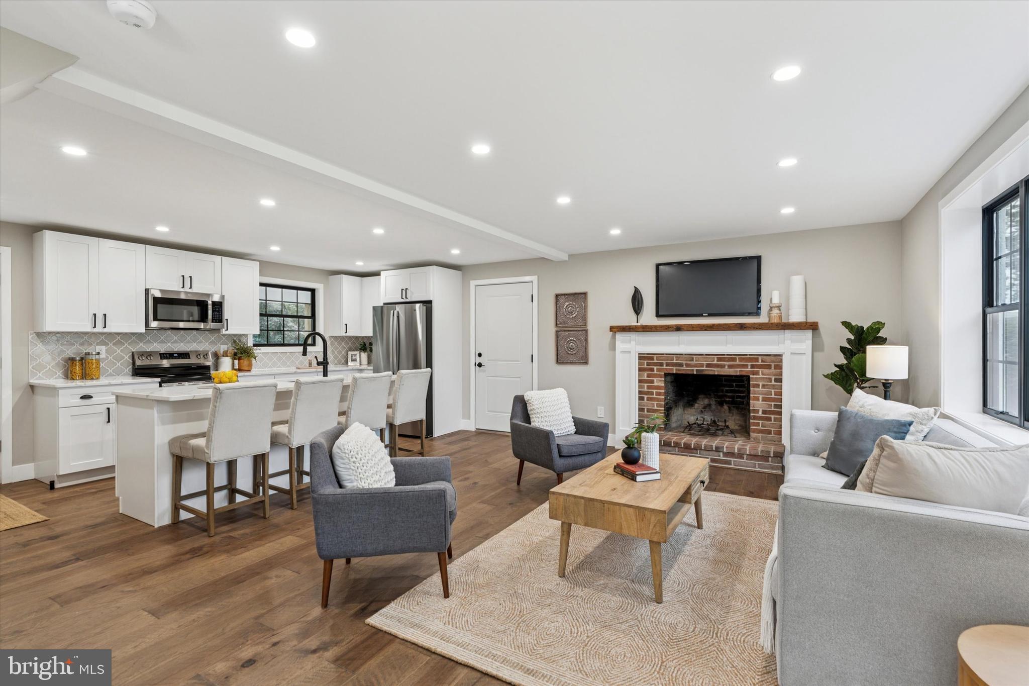 306 Greenhill Road West Chester, PA 19380 - Photo 5 of 42 a living room with furniture fireplace and kitchen view