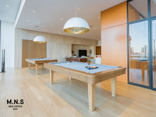 a kitchen with kitchen island granite countertop a sink a counter top space and living room view