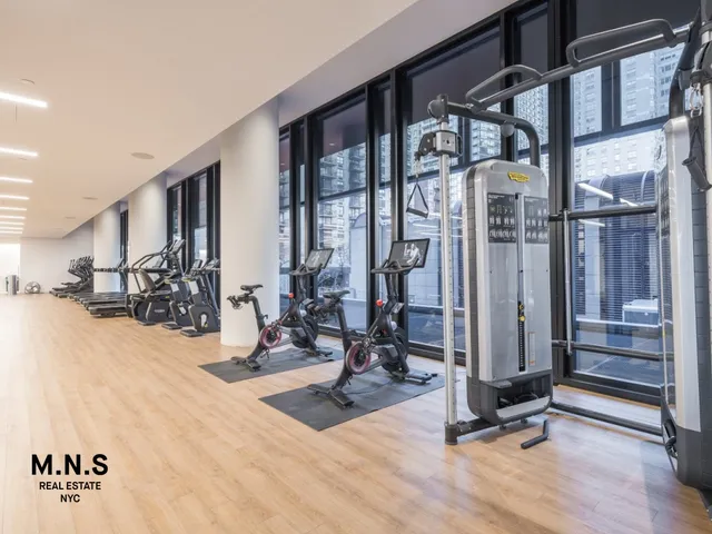 a living room with furniture a window and a wooden door