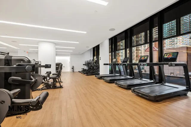 a white kitchen with a stove a sink and a refrigerator