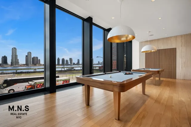 a lobby with furniture and floor to ceiling window
