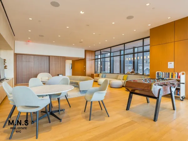 a view of a living room and kitchen floor to ceiling window