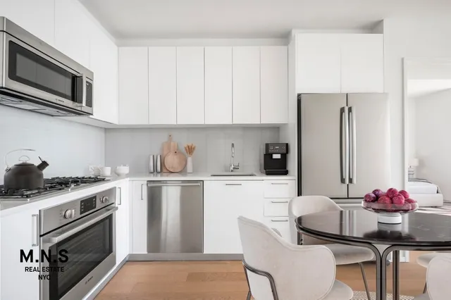 a bedroom with a bed and glass walk in closet