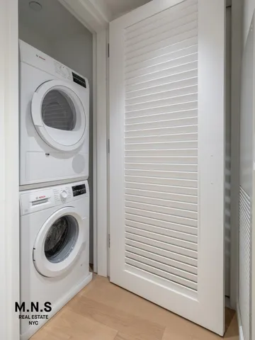 a kitchen with stainless steel appliances a stove a sink cabinets and a dining table