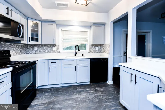 a kitchen with a sink stove and microwave