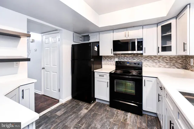 a kitchen with stainless steel appliances a stove microwave and refrigerator