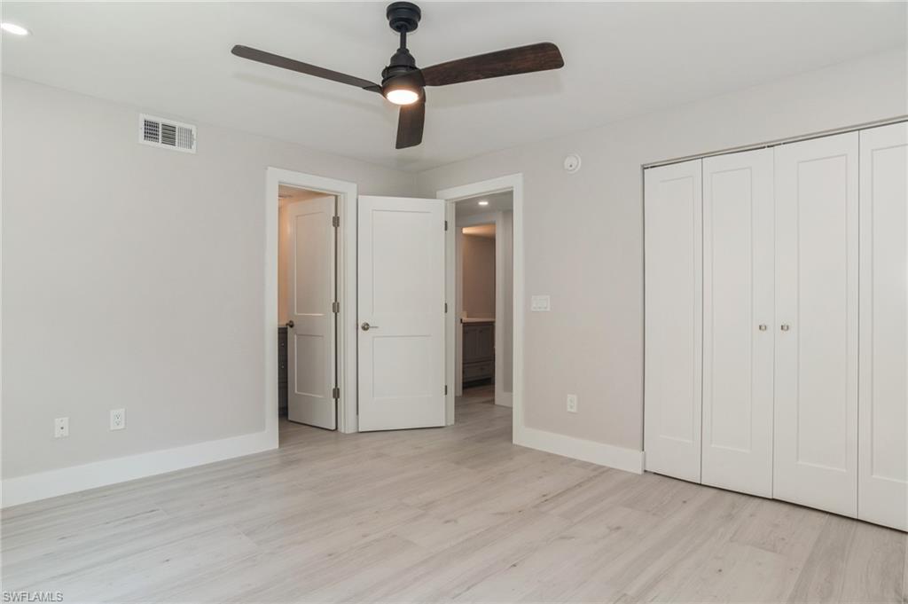 1155 Sandpiper Street, Unit B3 Naples, FL 34102 - Photo 9 of 21 Unfurnished bedroom featuring light wood-style flooring, ceiling fan, recessed lighting, and a closet