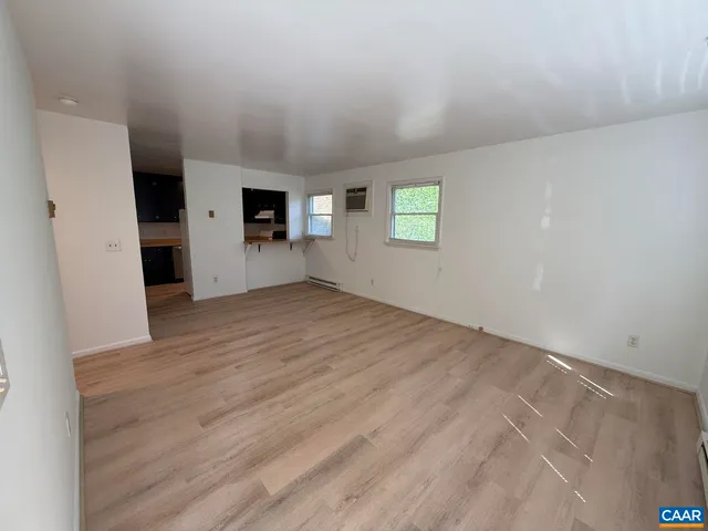 an empty room with windows and closet