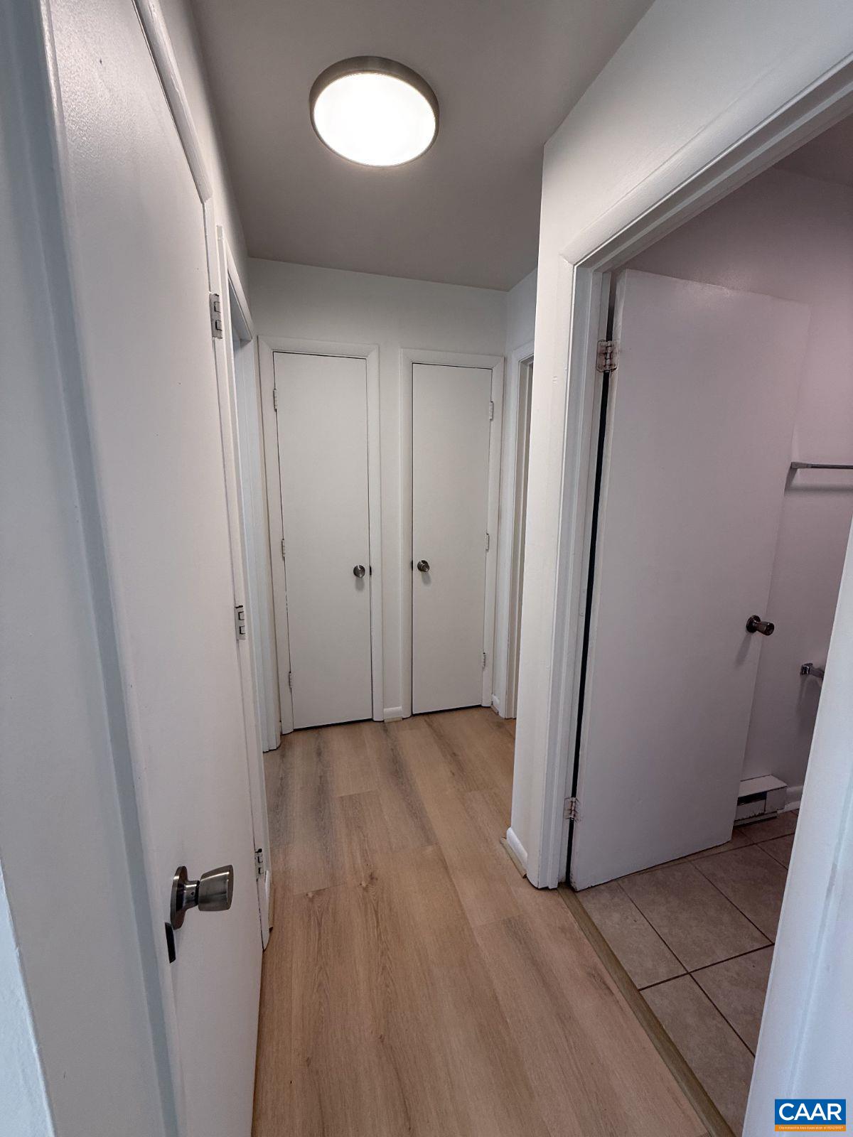 301 Paton Street, Unit A & B Charlottesville, VA 22903 - Photo 18 of 40 an empty room with wooden floor and mirror