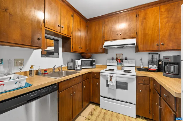 a kitchen with a white cabinets stove and sink