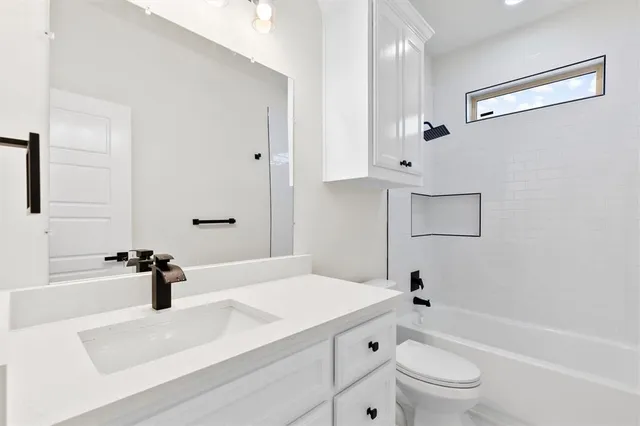 a bathroom with a sink a toilet and a bathtub