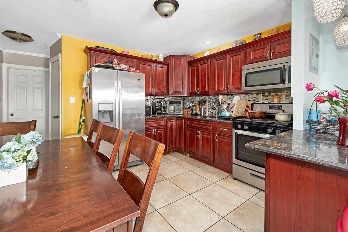 4016 Wilder Avenue Bronx, NY 10466 - Photo 11 of 17 a kitchen with stainless steel appliances granite countertop a sink counter space and cabinets