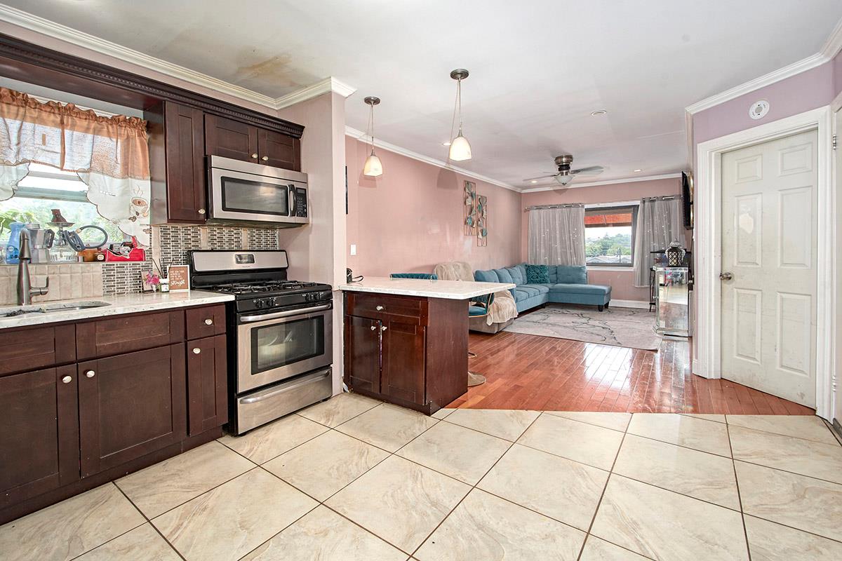 4016 Wilder Avenue Bronx, NY 10466 - Photo 17 of 17 a kitchen with stainless steel appliances granite countertop a stove a sink dishwasher and a refrigerator