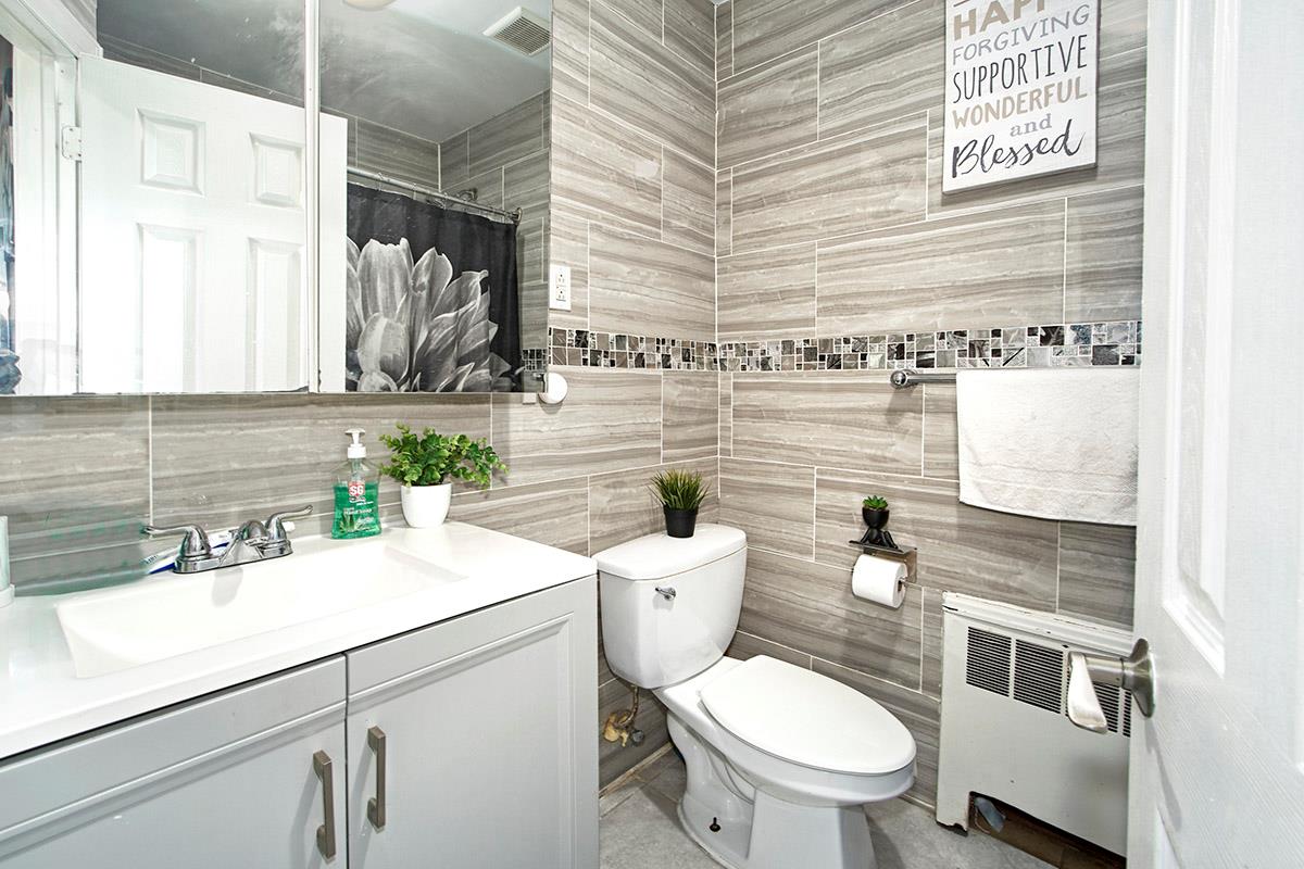 4016 Wilder Avenue Bronx, NY 10466 - Photo 15 of 17 a bathroom with a sink a toilet and a mirror