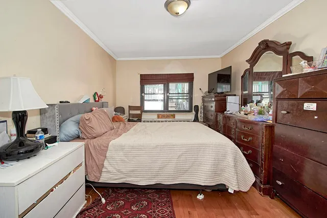 a bed sitting in a bedroom next to a window