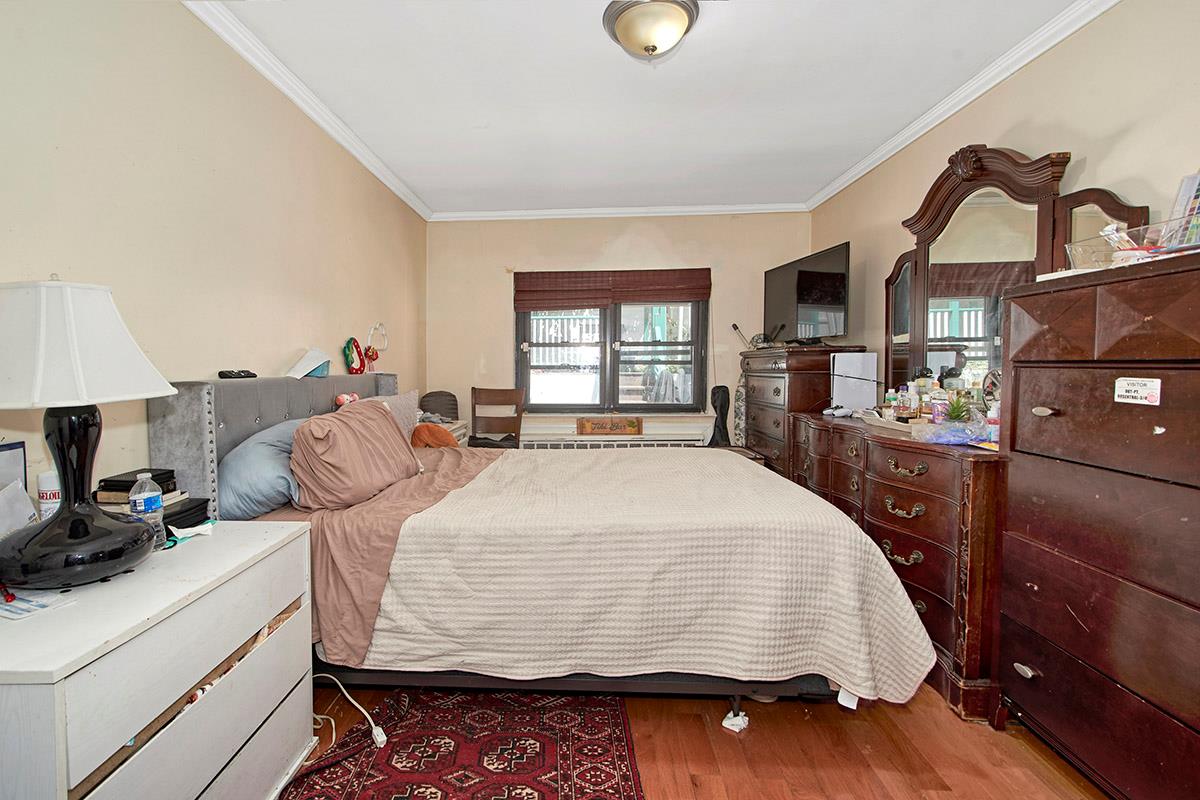 4016 Wilder Avenue Bronx, NY 10466 - Photo 5 of 17 a bed sitting in a bedroom next to a window