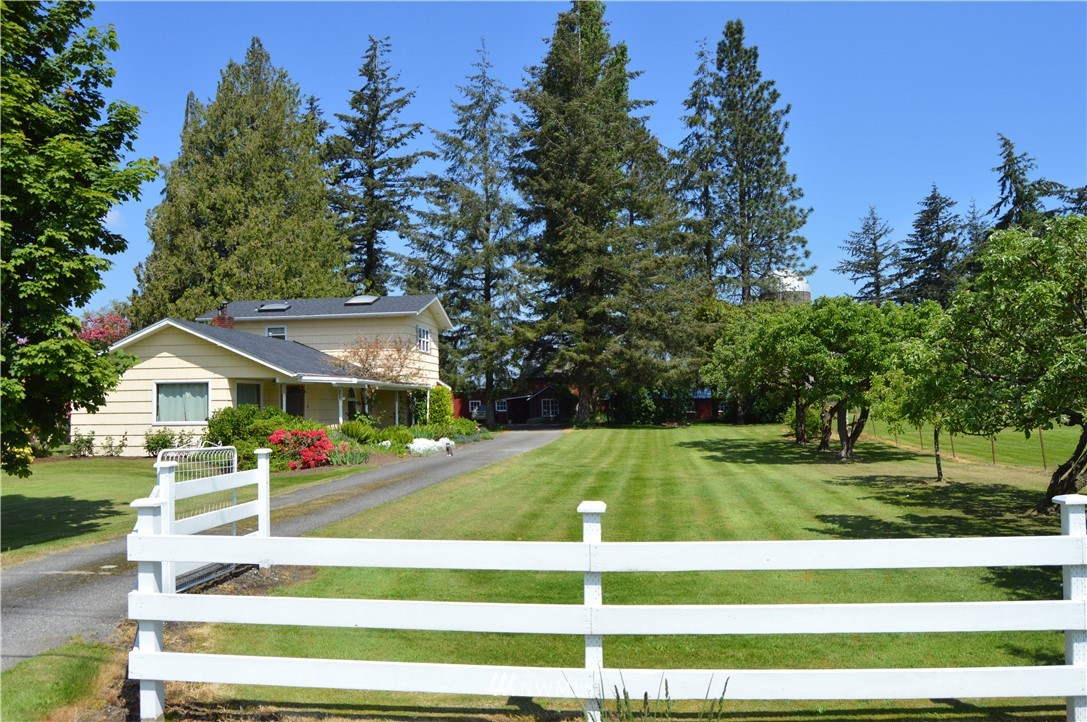 590 West Pole Road Ferndale, WA 98248 - Photo 1 of 40 a view of a house with a big yard and palm trees